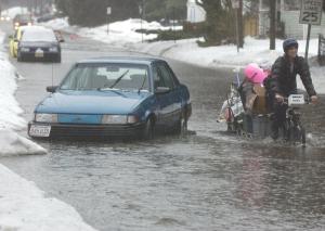 Jackie pedals through the flood